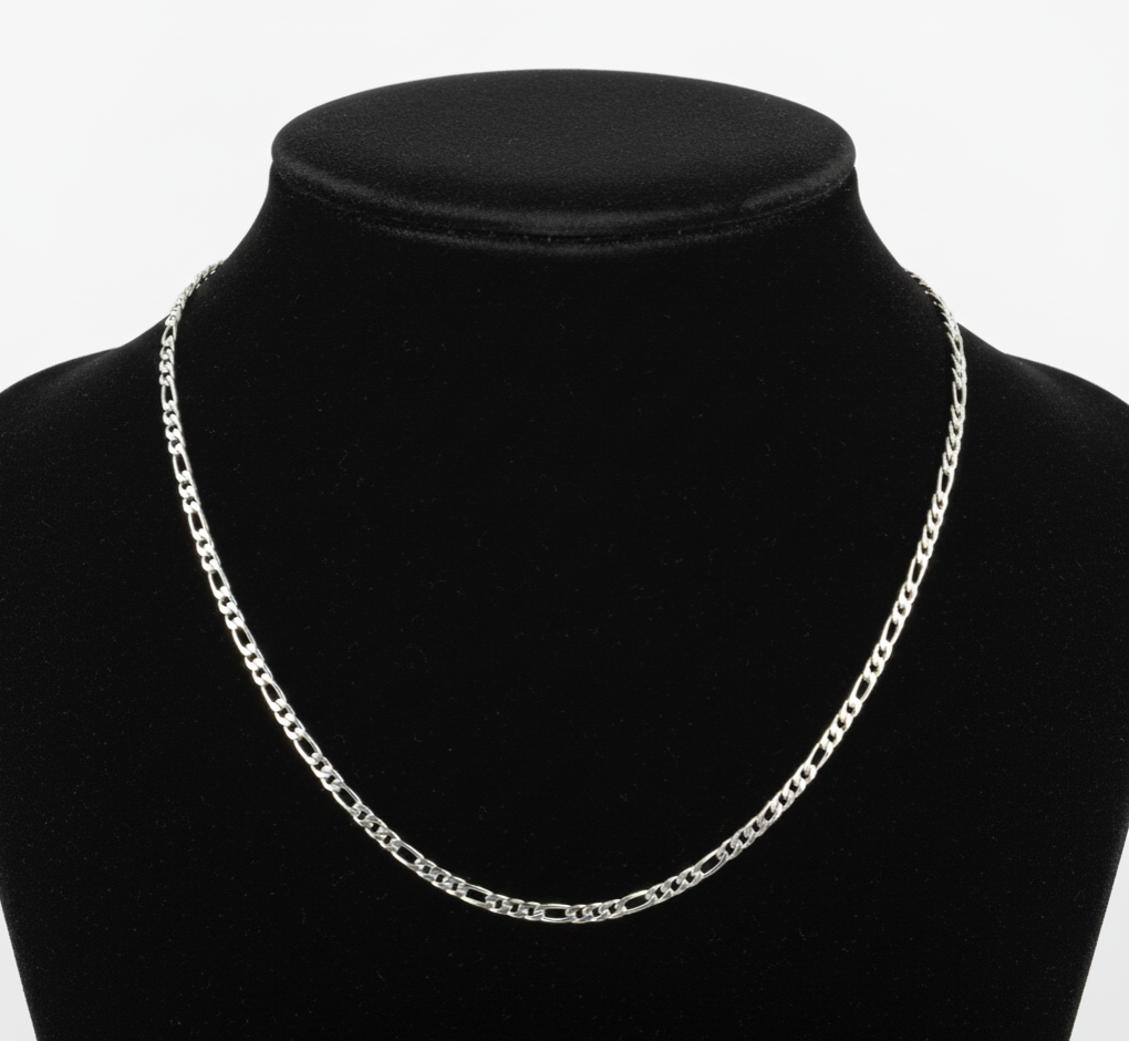 Silver chain necklace on a black mannequin bust against a white background