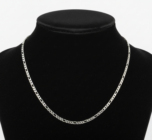 Silver chain necklace on a black mannequin bust against a white background